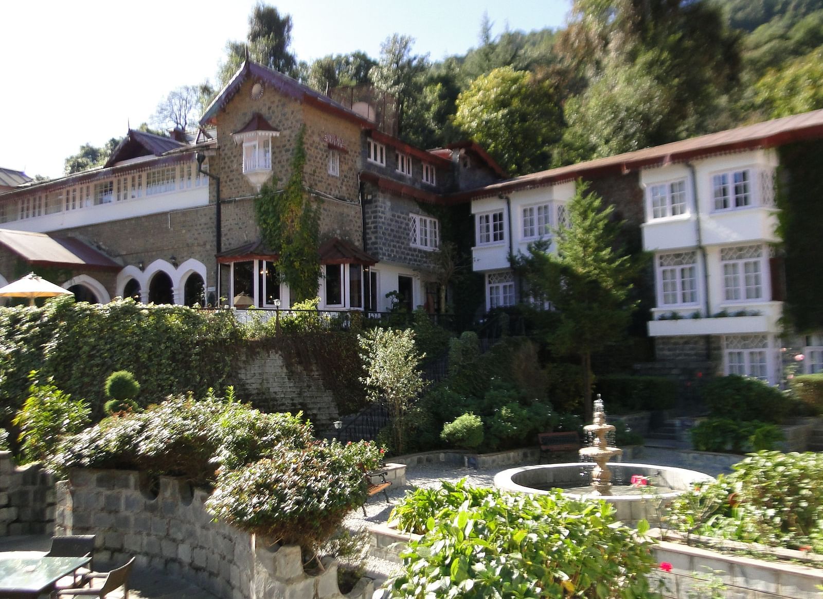 Picture featuring hotel in scenic mountain setting with lush gardens.