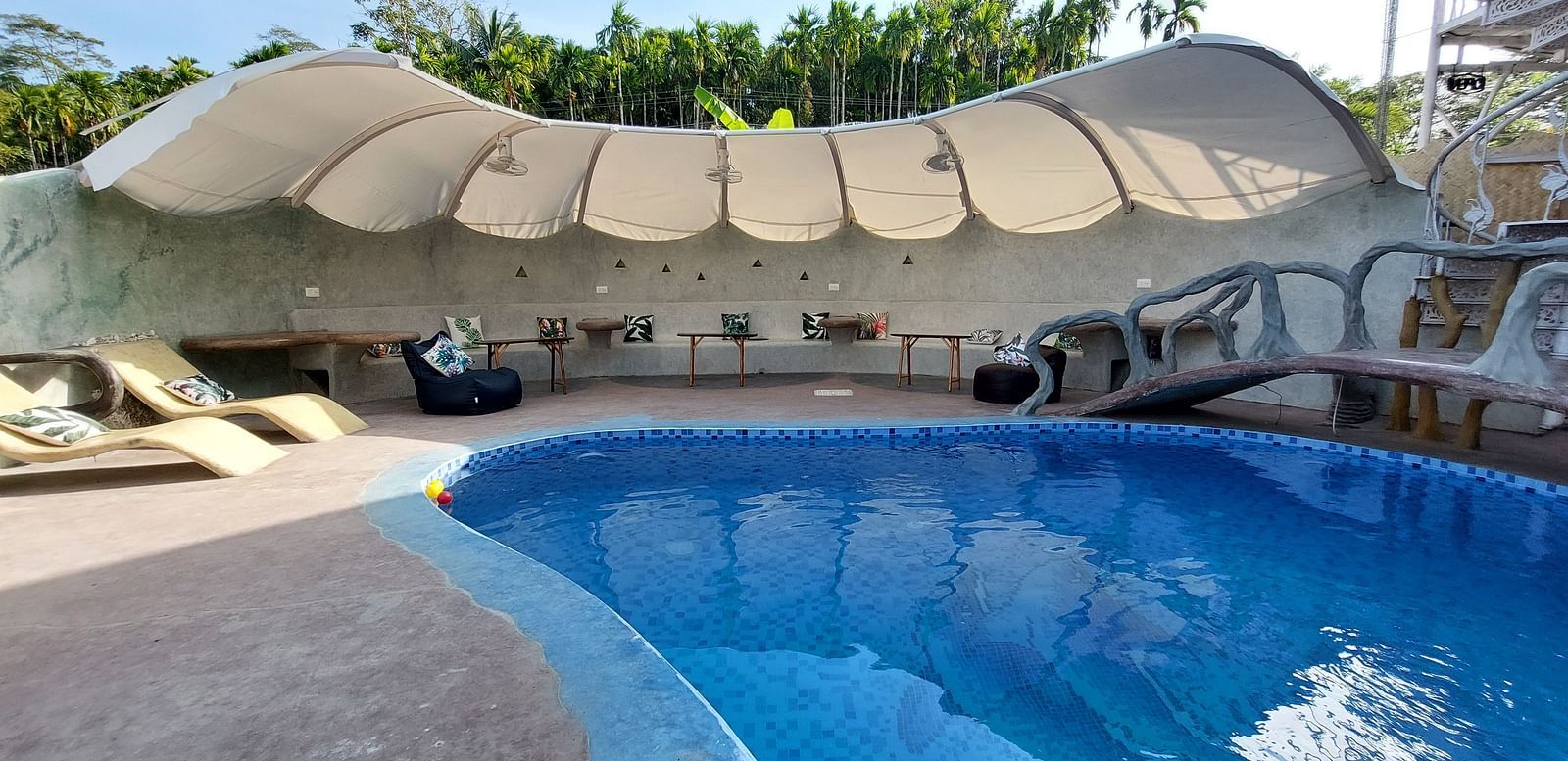 Inviting swimming pool with shaded loungers at Matsya Island Retreat