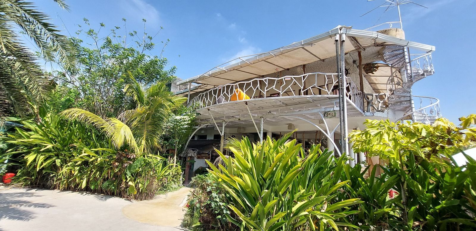 Lush green entrance of Matsya Island Retreat with rustic architectural design