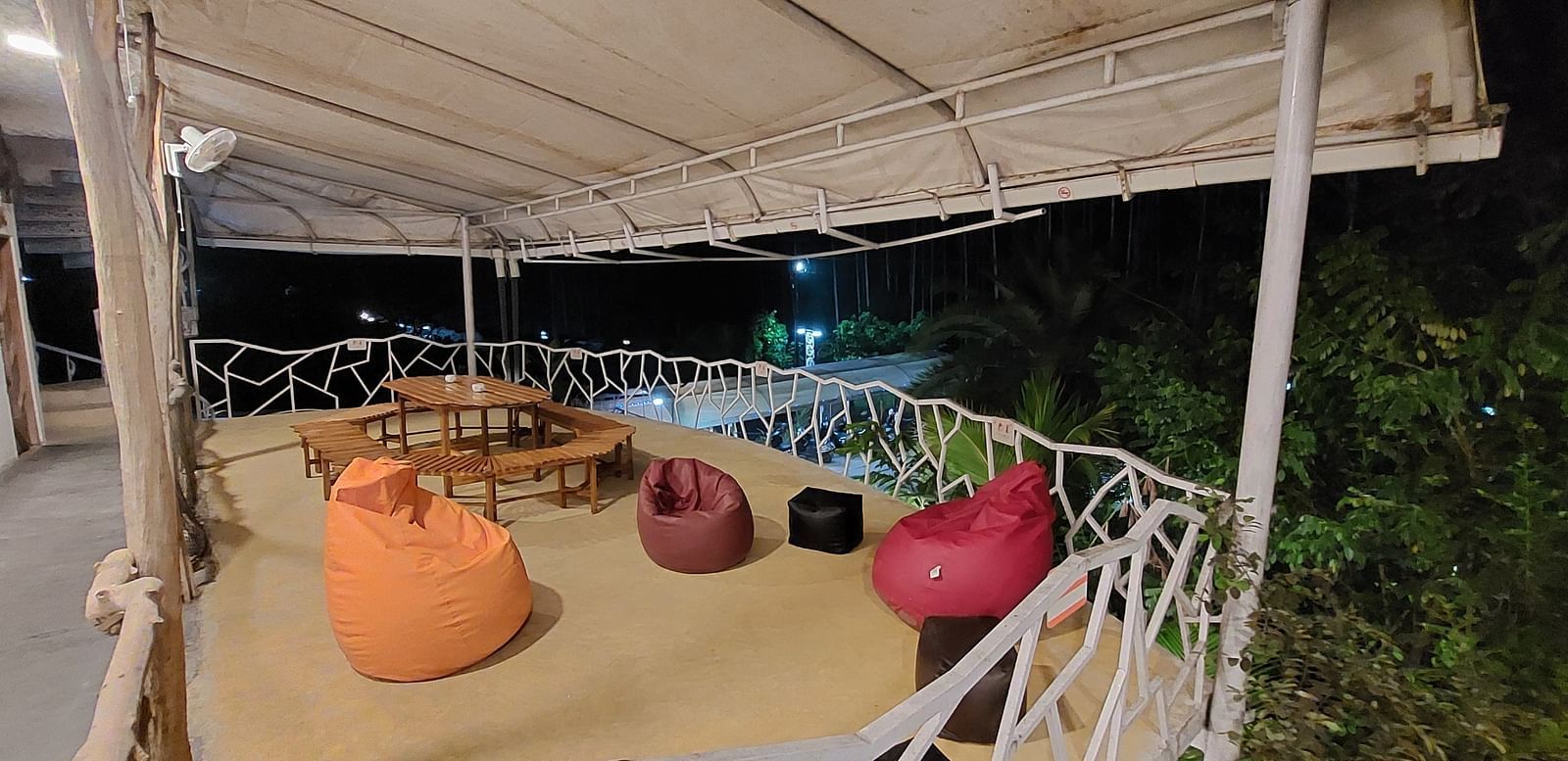 Relaxed seating area with colorful bean bags under a canopy at Matsya Island Retreat