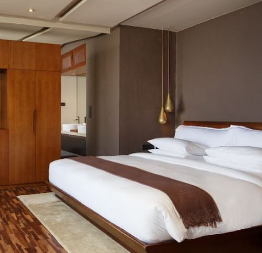 An image of a bedroom which also had a flat TV screen on the wall | Kavya Resort and Spa, Nagarkot