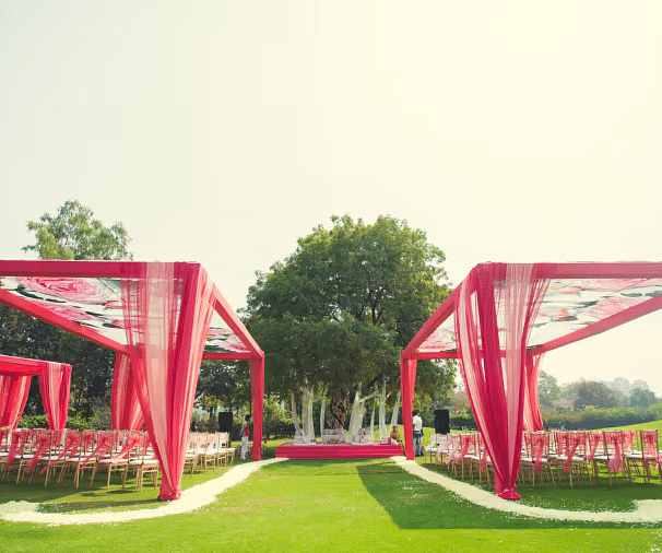 Outdoor area with wedding decorations on green lawn at Karma Chalets.