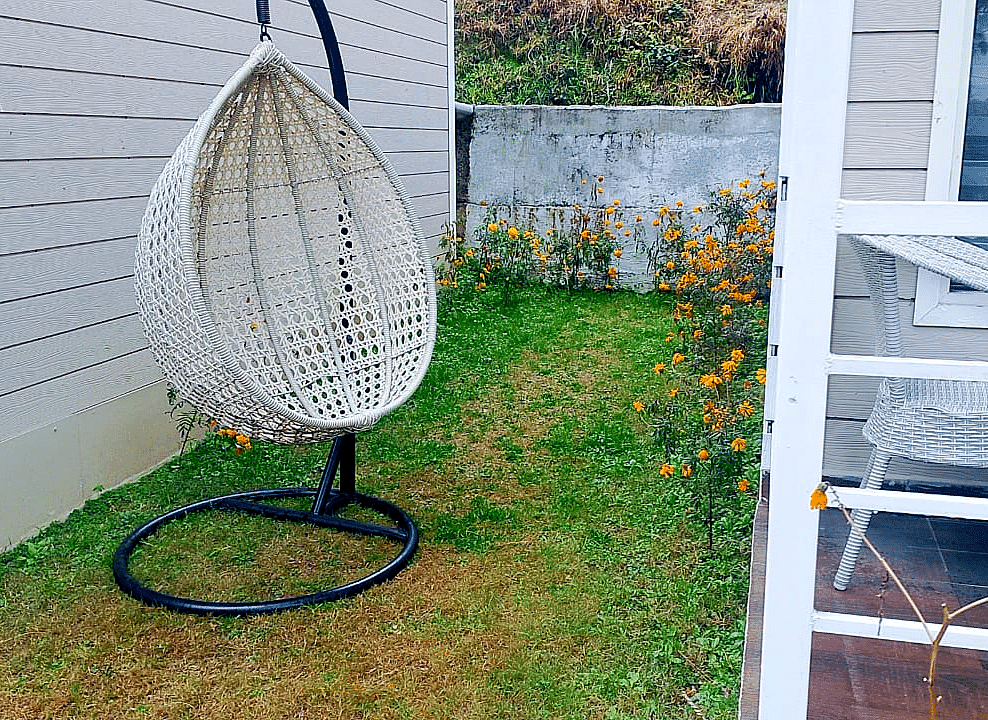 Lawn area at DLS Nature Trinket Resort with swing and grass.