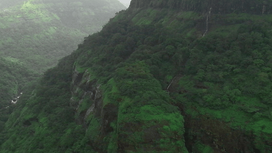A panoramic view of the Shooting Point, one of the Khandala Hills, with mountains covered with lush trees amid misty surroundings