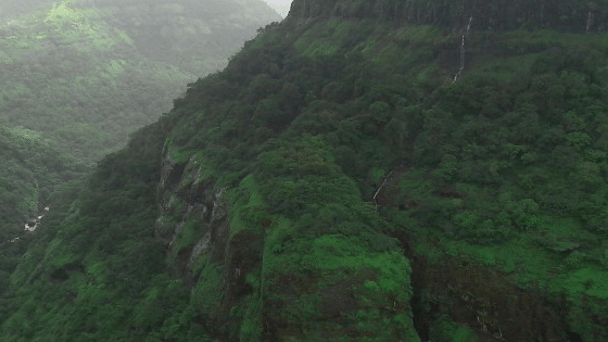 A panoramic view of the Shooting Point, one of the Khandala Hills, with mountains covered with lush trees amid misty surroundings