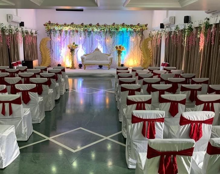 Event space at Mayur Retreat set up with decorated chairs and a view of the stage in the background.