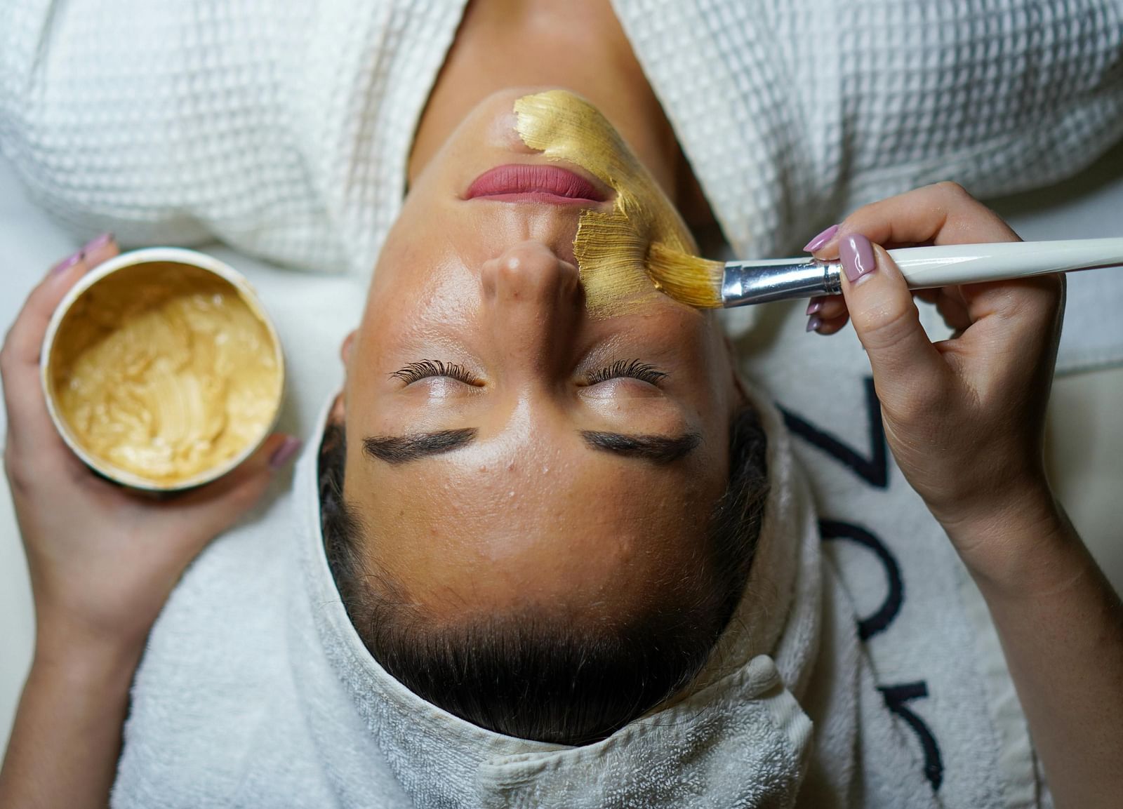 A lady getting a spa treatment done on her face