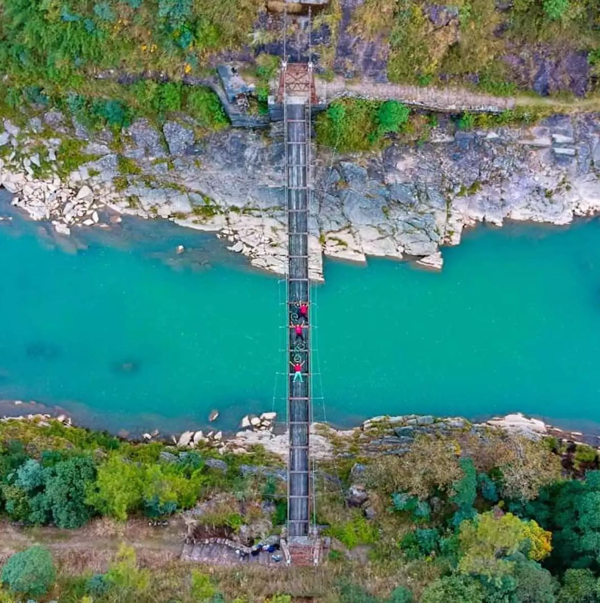 An aerial view of a bridge over a river near Polo Resort Cherrapunjee.