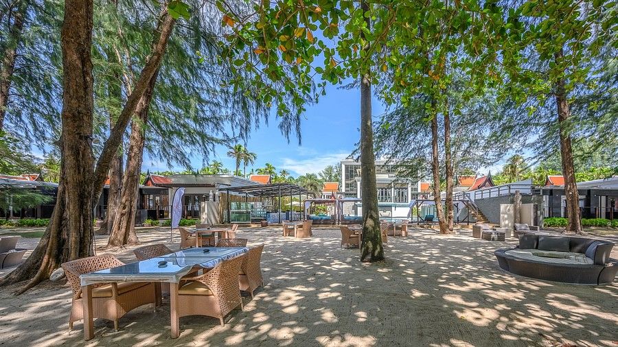 an image of the outdoor dining area on the with nicely arranged tables and chairs on the sand - Maikhao Dream Villa Resort & Spa, Phuket