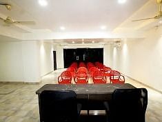 A spacious hall with tables and chairs arranged neatly at SeaFort Beach Resort