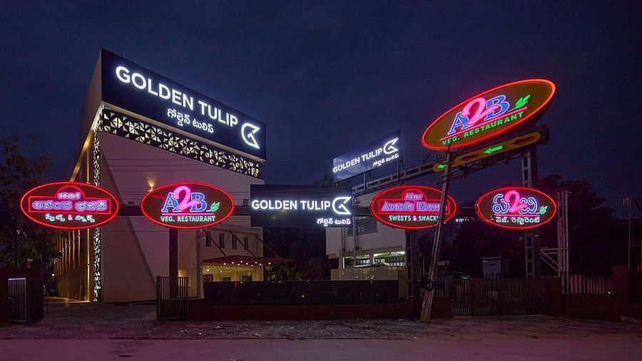 the exterior facade of the hotel along with signs of a restaurant - Golden Tulip, Tirupati