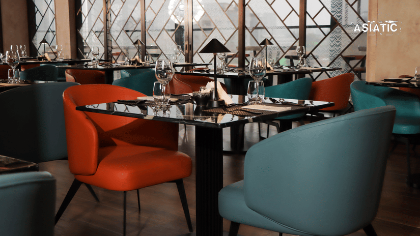 Asiatic Lounge interiors featuring tables, chairs, with glasses on top of the tables.
