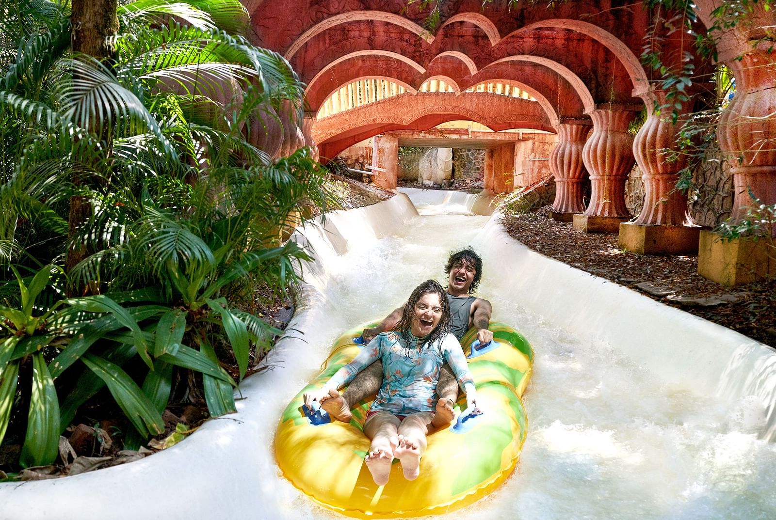 An image of a man and a lady enjoying the Adventure Amazonia ride on a tube - Water Kingdom