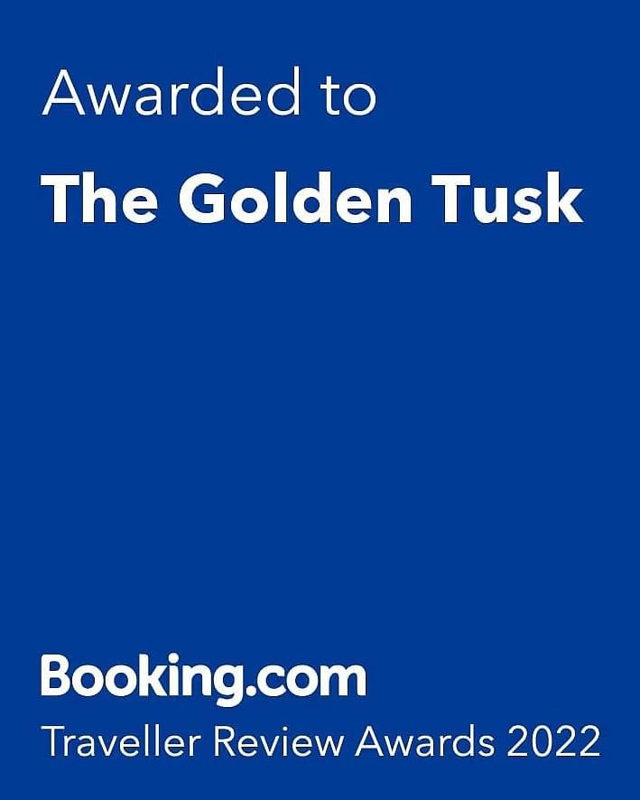 A creative by Booking.com awarded to the Golden Tusk Resort for the traveller review awards in 2022 giving a rating of 9.3.