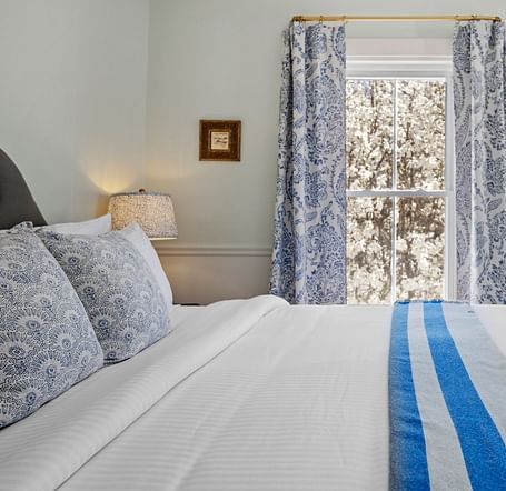 A Room with blue patterned drapes and a seating area in the corner at Hartstone Inn