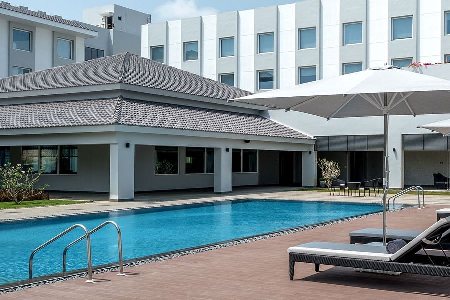 exterior of The Residency Towers Rameswaram with a swimming pool in front of it