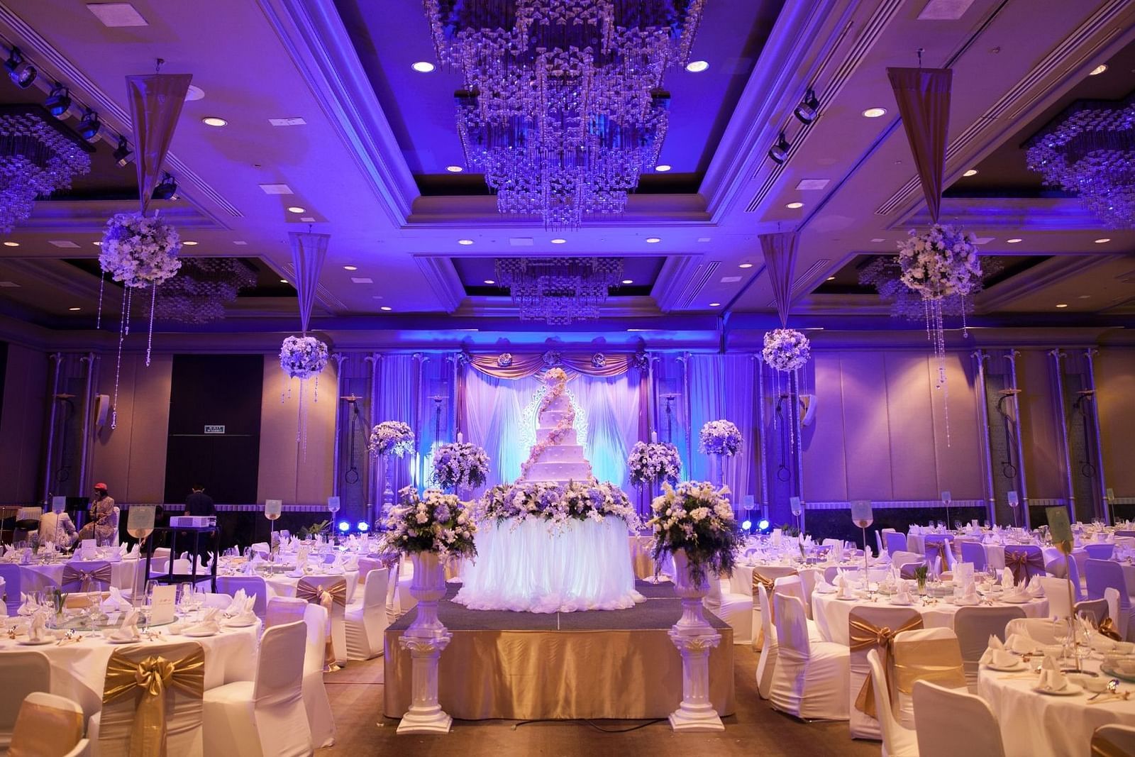 round table seating and chandeliers on the roof of the Banquet Hall at Rhythm Gurugram