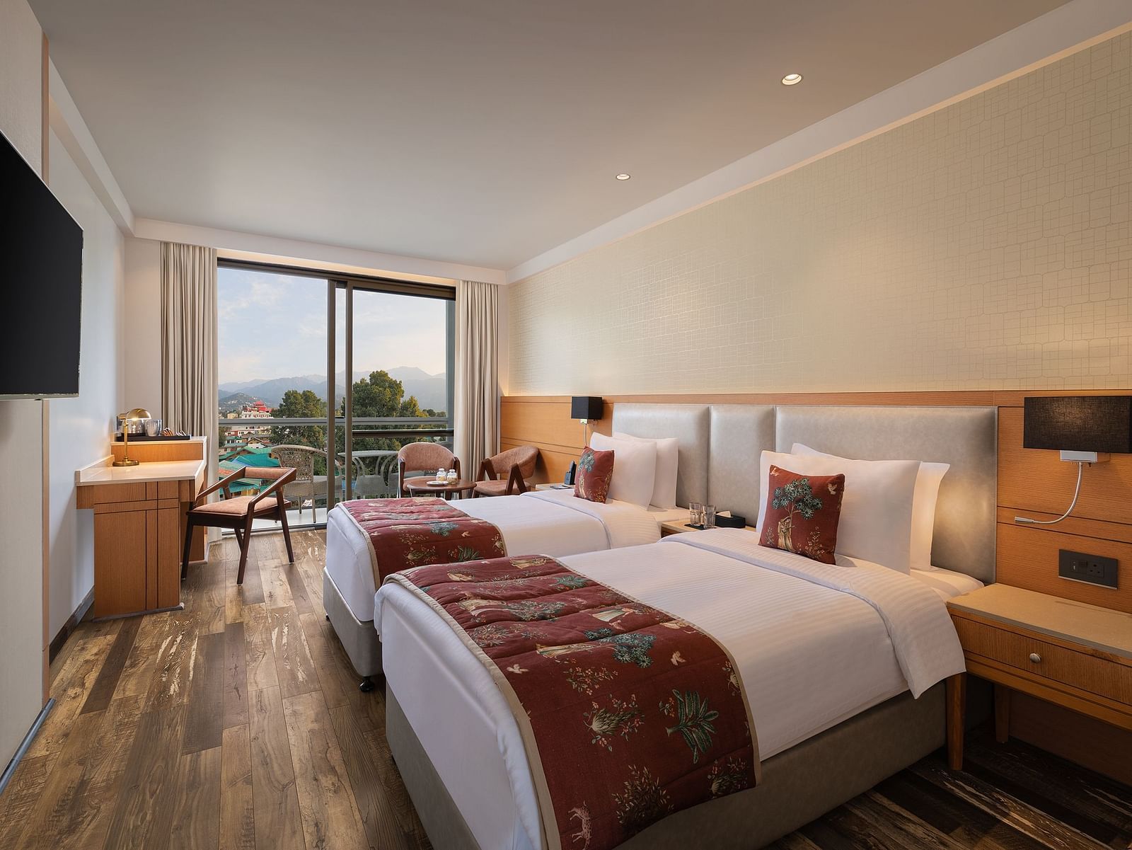 Premium peaks room at Infinitea Centric, Dharamshala with twin beds and a television