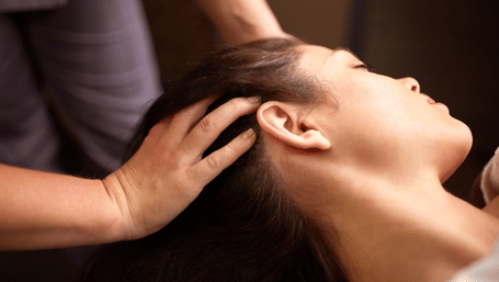 A person getting a head massage.