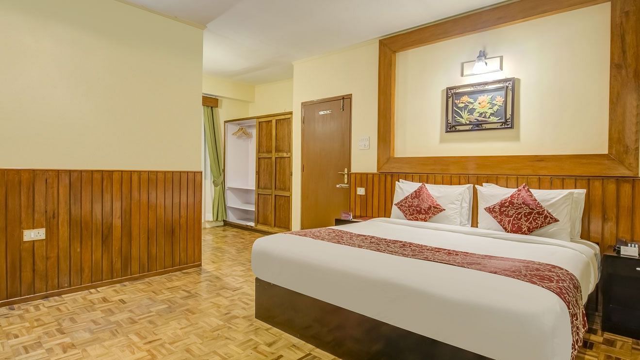 Image of a room with bed and wooden wall panels at Summit Tashi Ghang Heritage Resort, Pelling