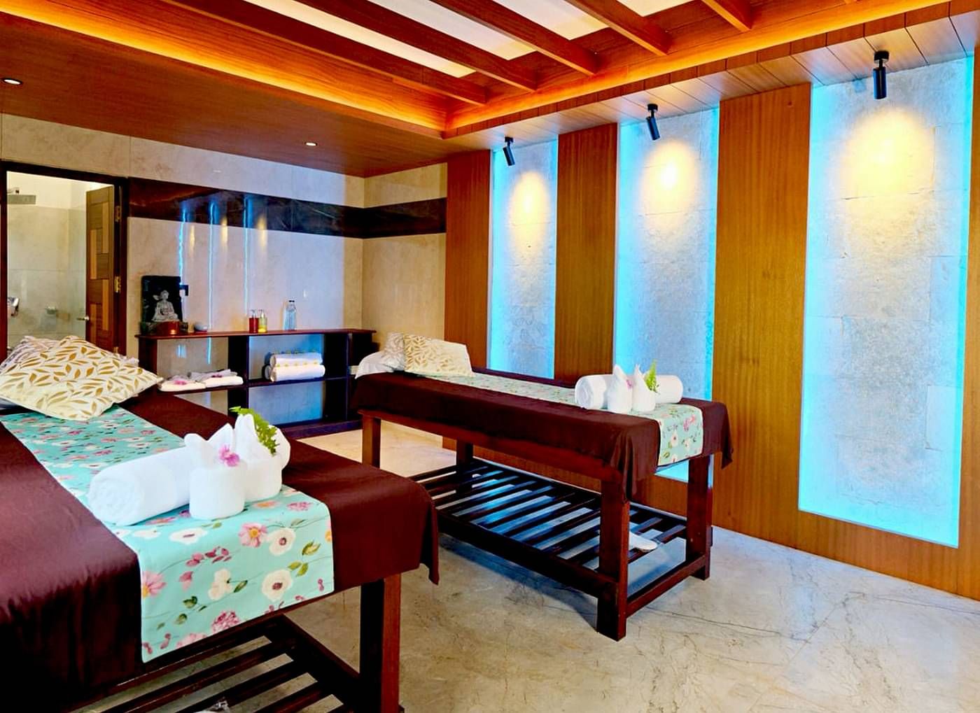 Spa room with ambient lighting and wooden interiors at Vythiri Resort, Wayanad