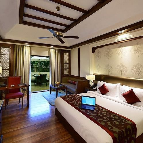 The interiors of our Super deluxe rooms in Pushkar featuring a double bed, a TV, a large window and tasteful decor 