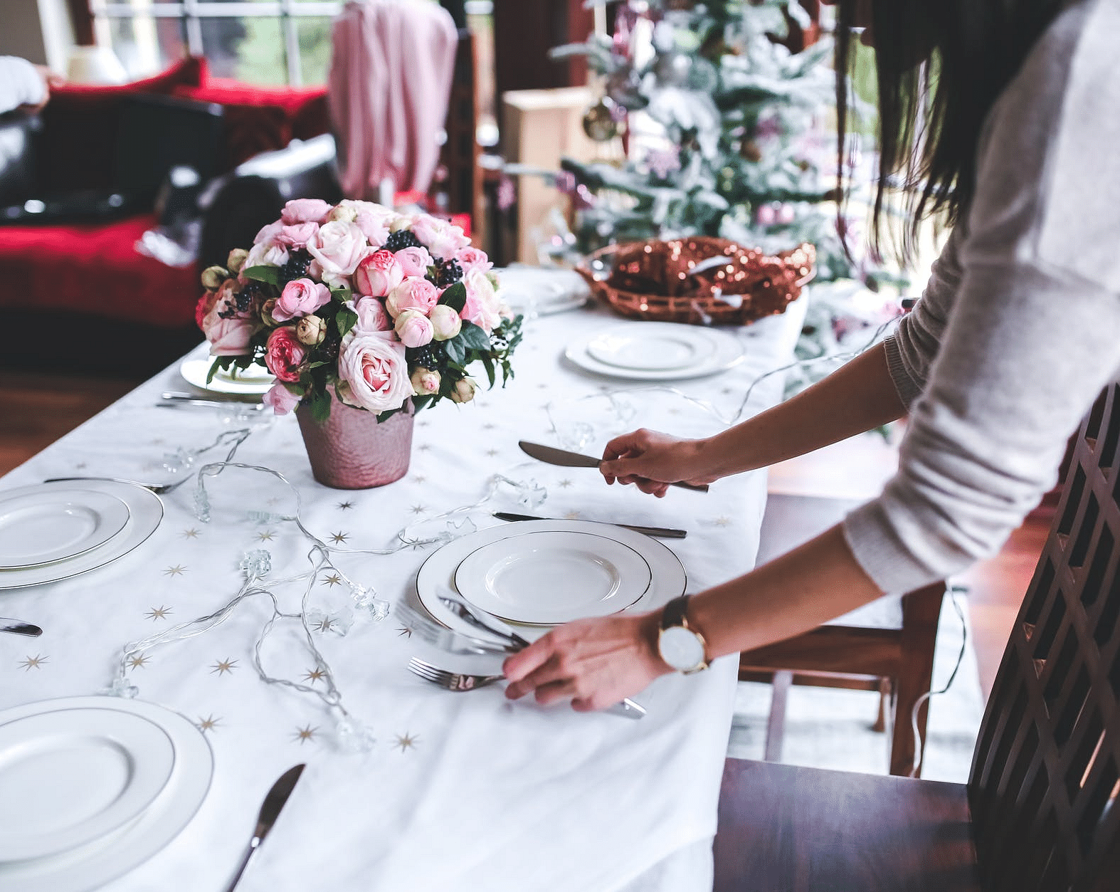 A person setting up a table for a meal in day time