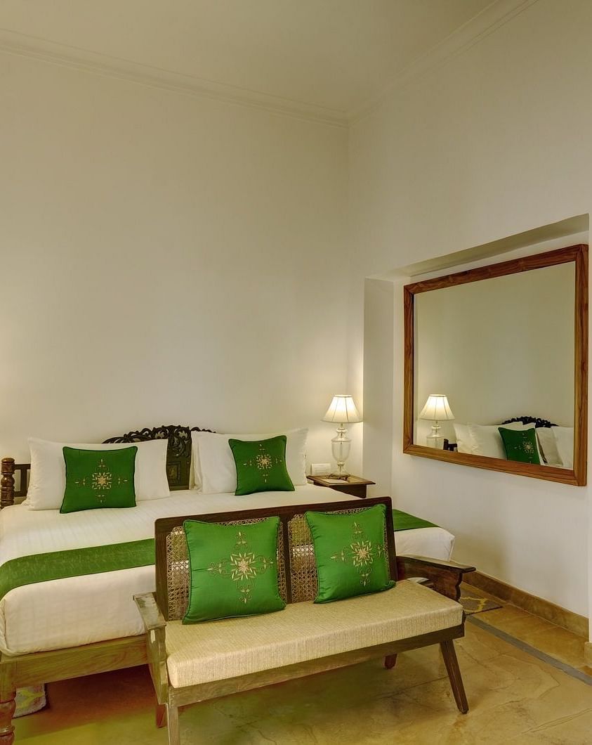 Awadh Room with a double bed and seating at Saraca Hotel, Lucknow
