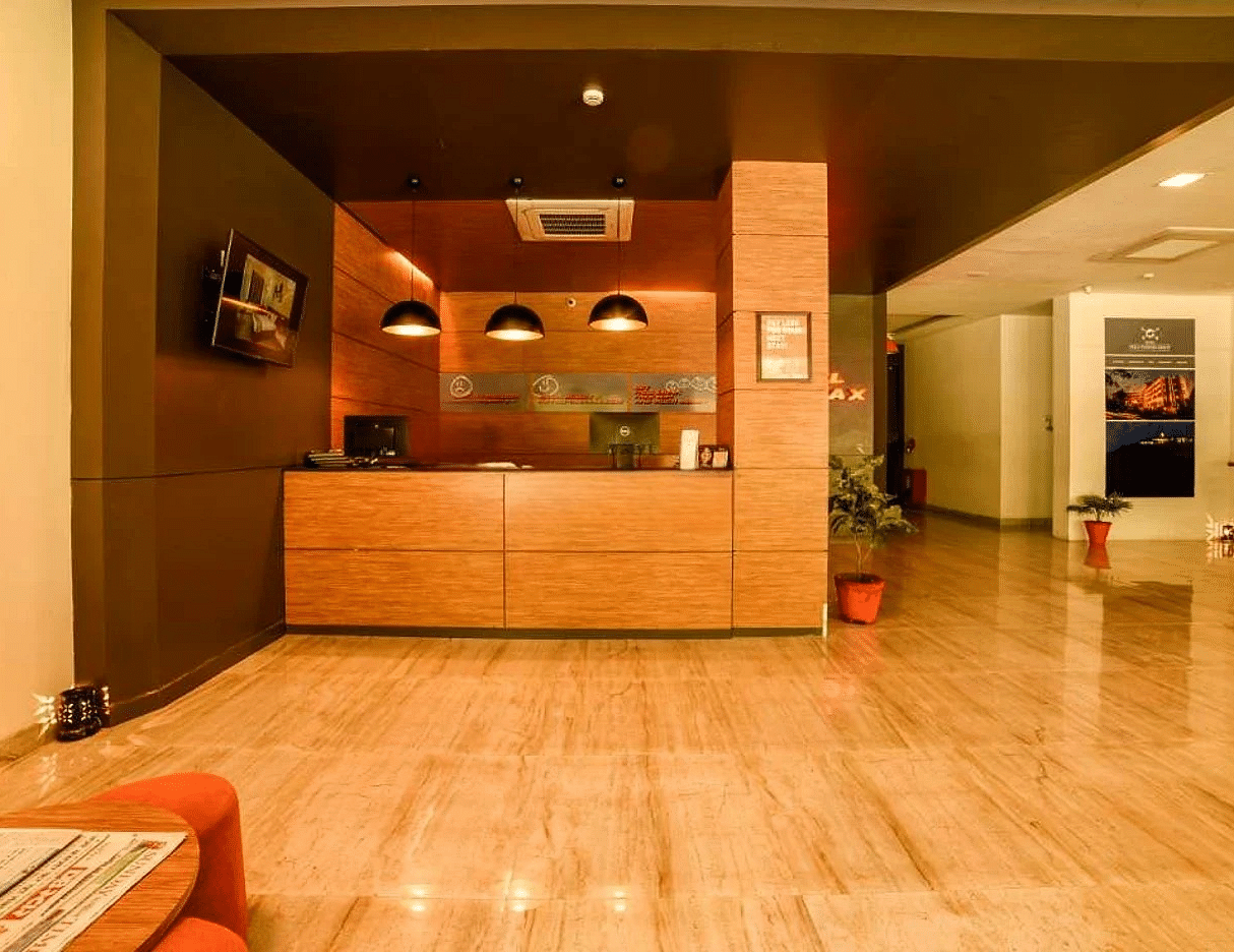front view image of the reception area of our hotel with a waiting area in front of it - Max Hotel Jabalpur