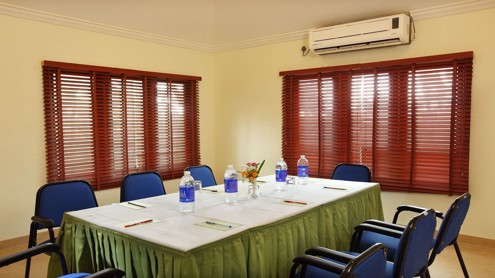Chairs and table arranged in a boardroom setup, ready for the meeting