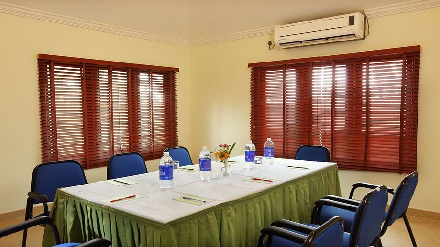 Chairs and table arranged in a boardroom setup, ready for the meeting