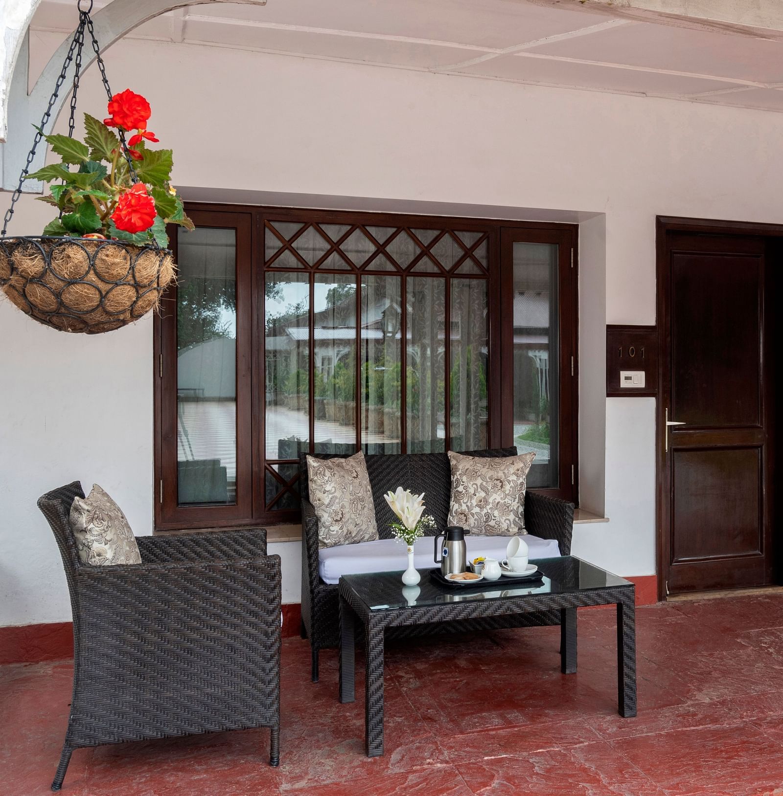 Outside seating area with a three seater couch at The Claridges Nabha Residence