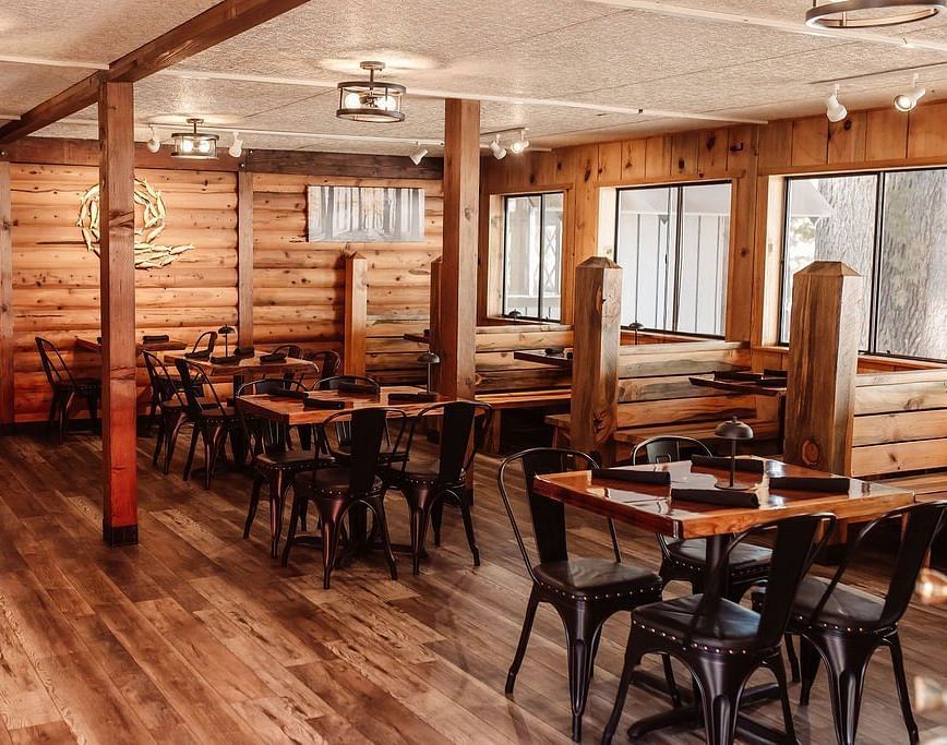 Interiors of a restaurant with wooden flooring and dining arrangement