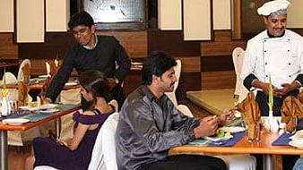 people dining at the orange restaurant at the grand palace, yercaud