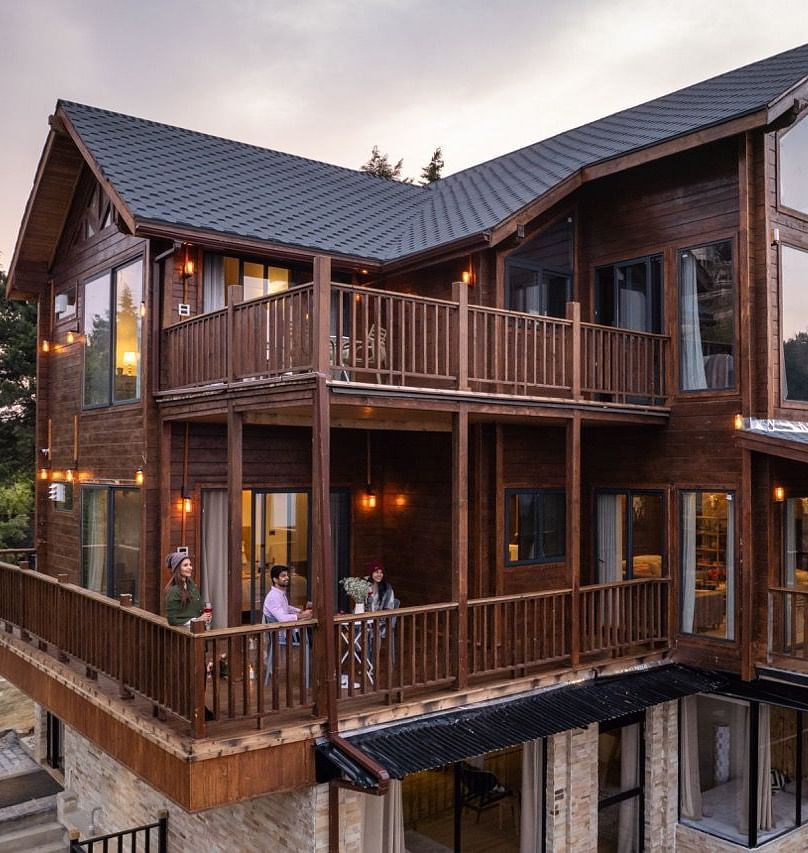 An image of a well lit cottage cottage with trees all around | Avalon Cottages, Kanatal