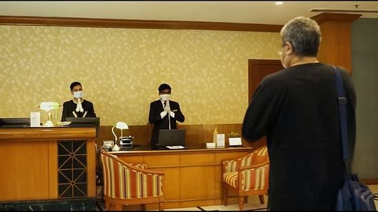 staff members at the orchid hotel welcoming a guest