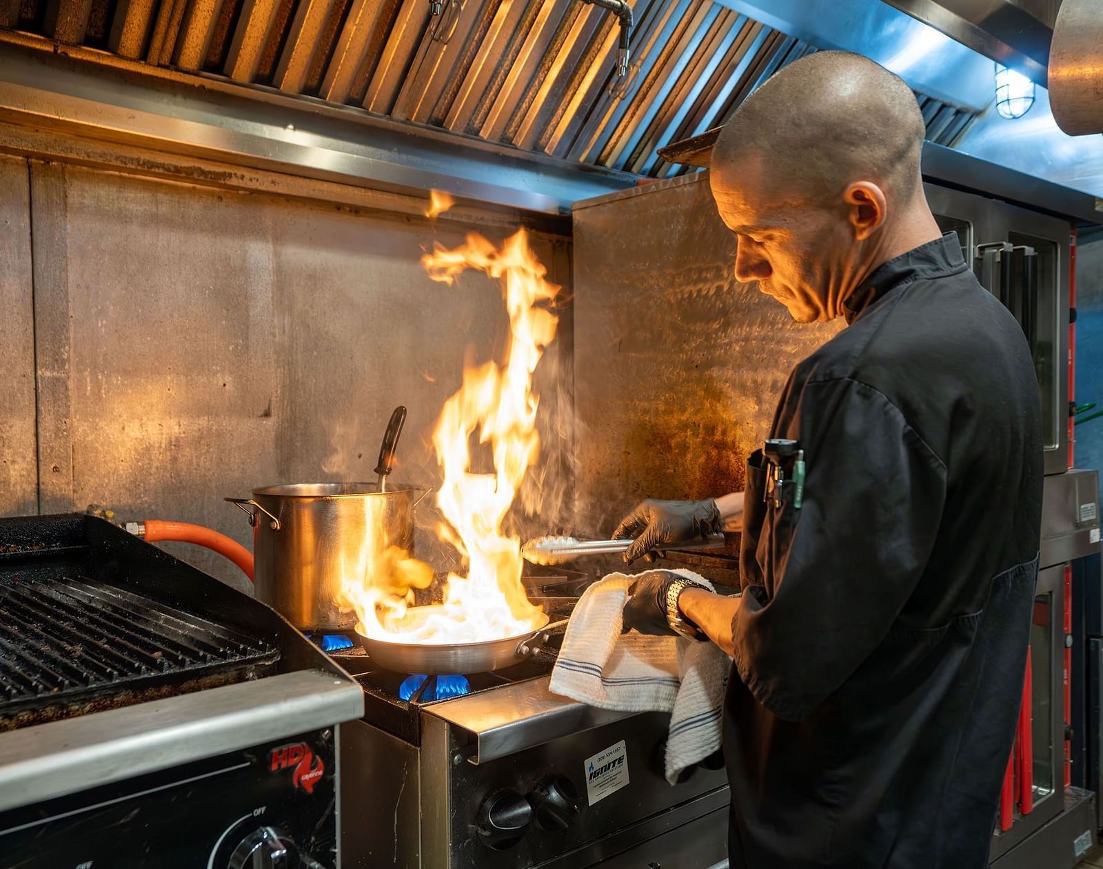 A chef cooking at the station in a commercial kitchen