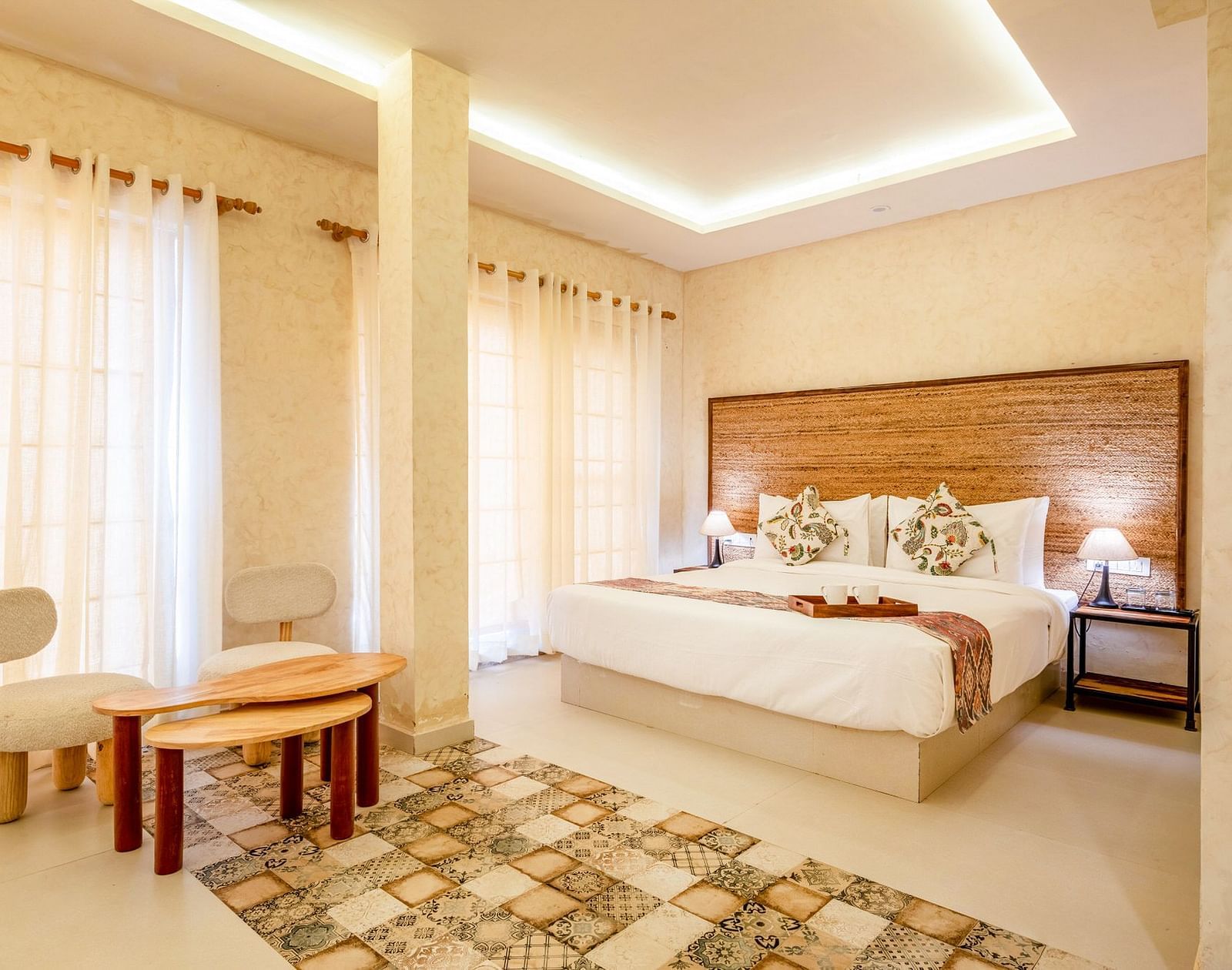 A room with a bed and a seating area in front at Valley by Grassfield.