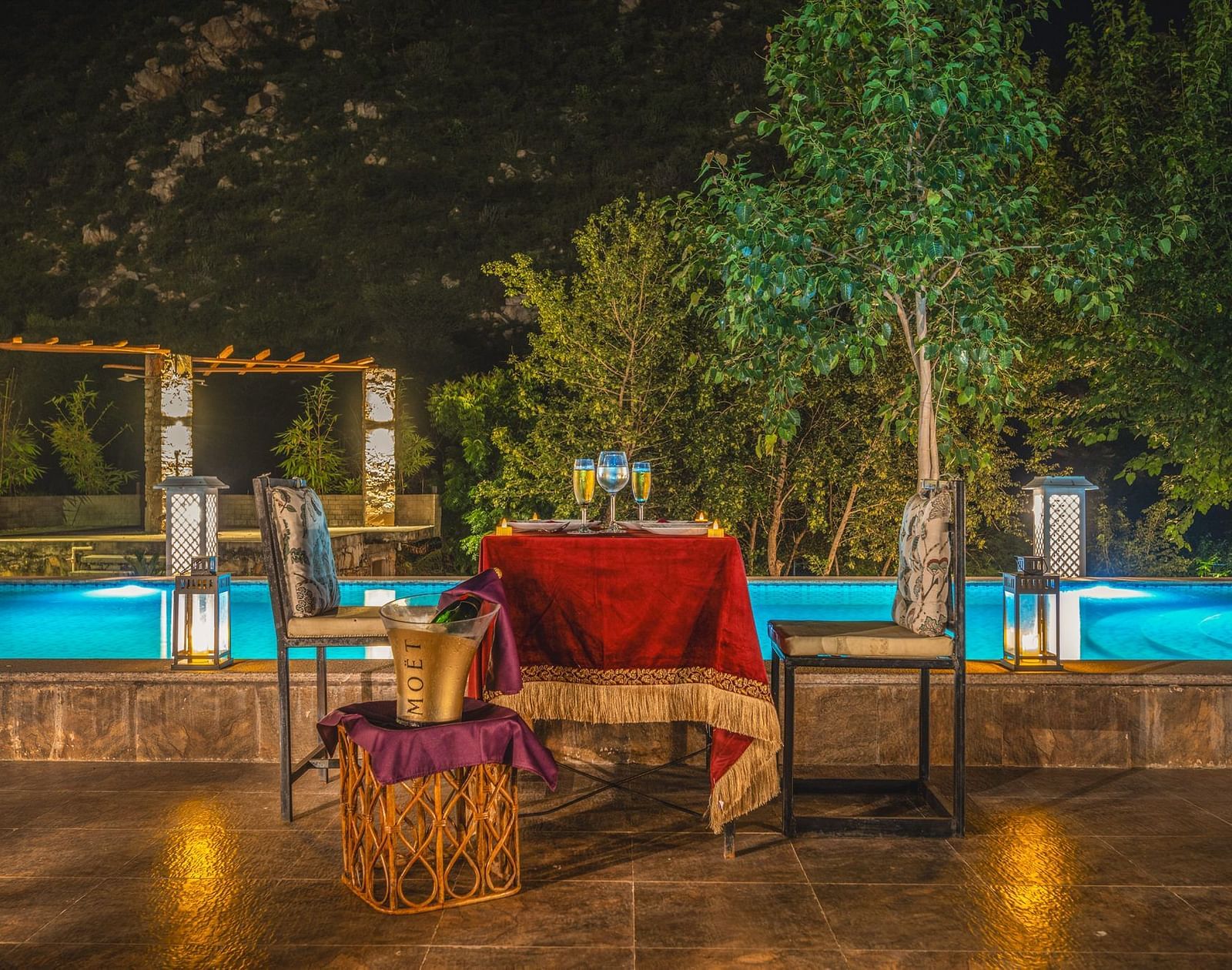 An outdoor dining area with a table and two chairs places beside a swimming pool at Valley by Grassfield.