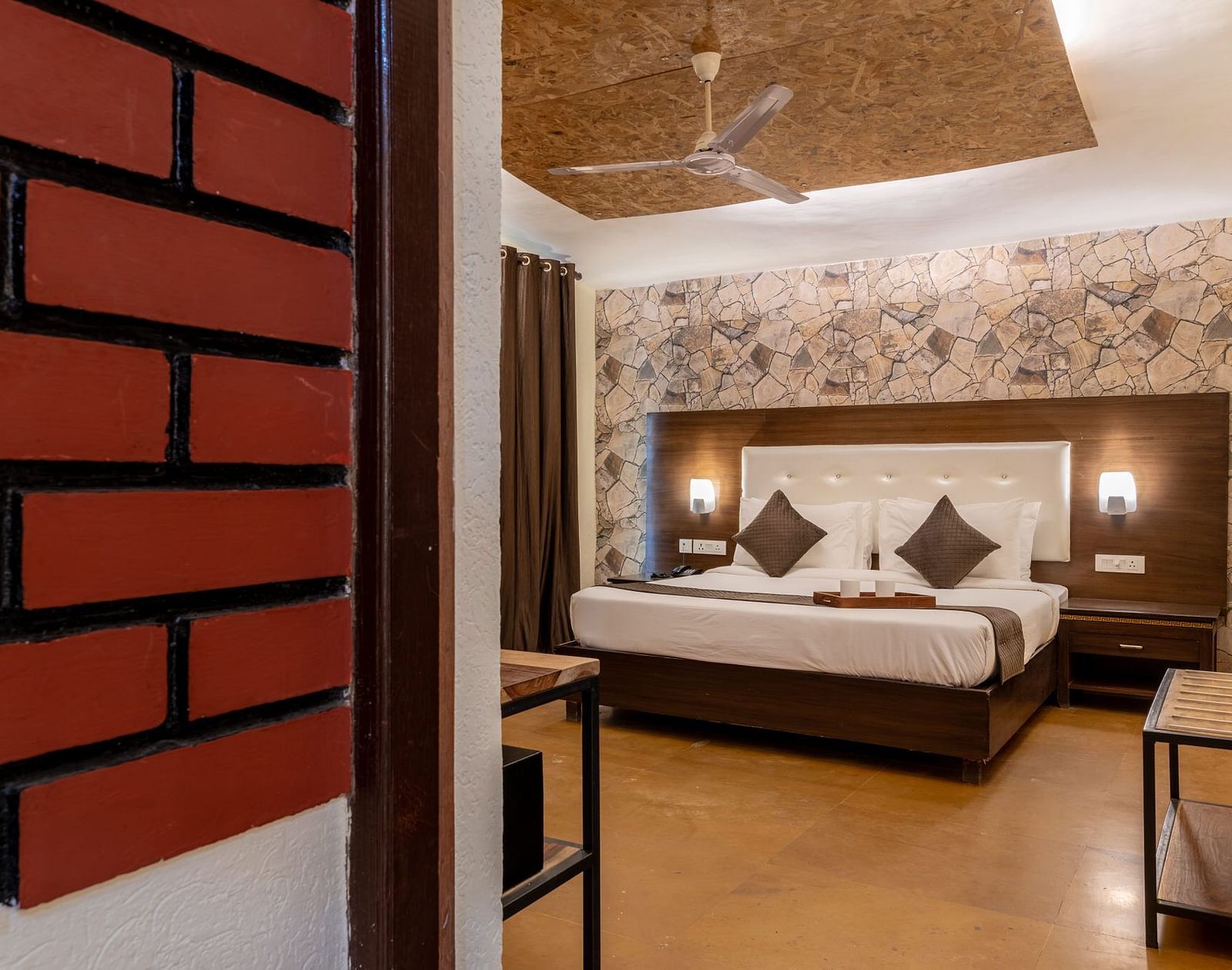 A room with a bed and a ceiling fan above the bed at Valley by Grassfield.