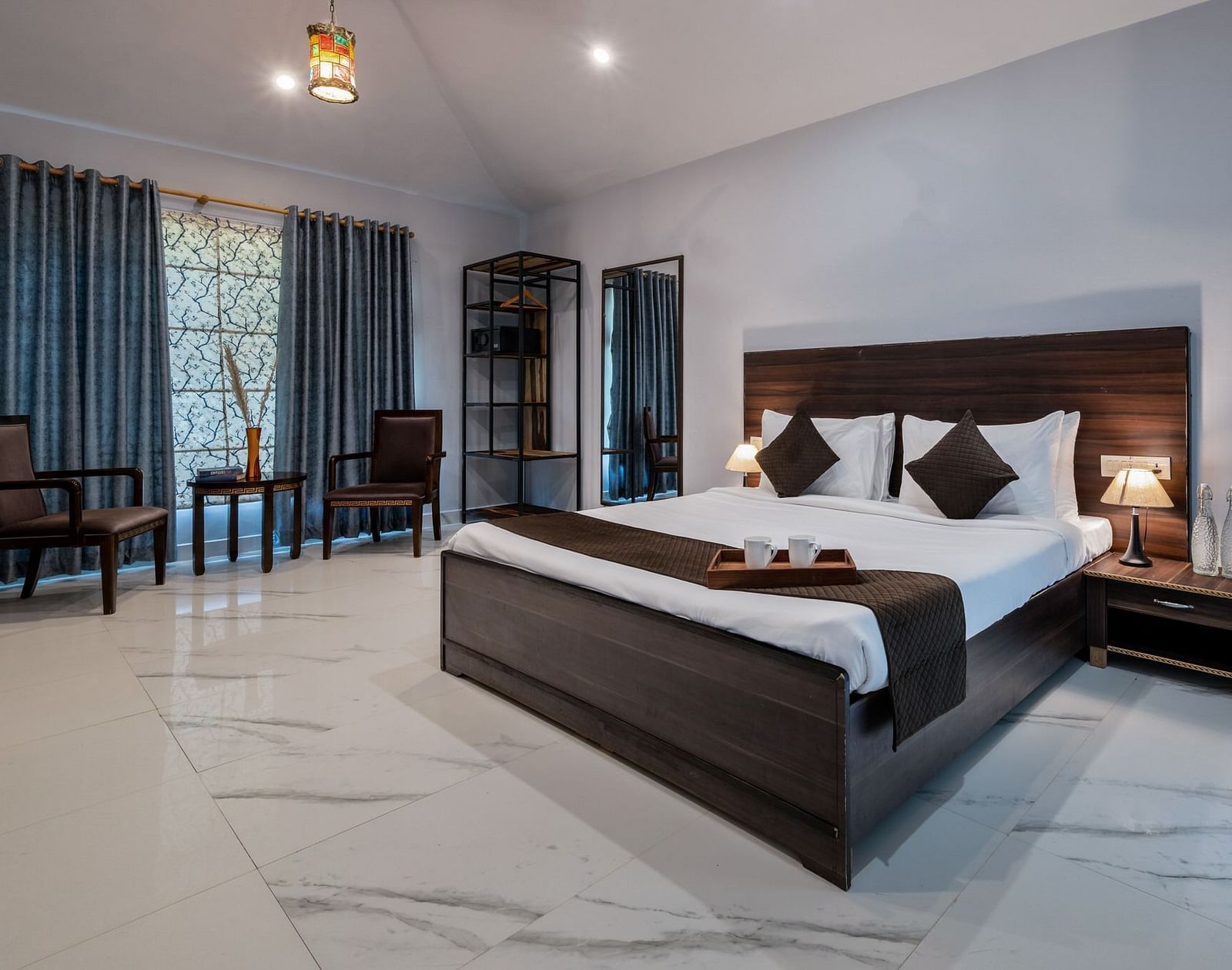 A room with a bed and a seating area on the side at Valley by Grassfield.