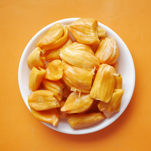 A plate full of jackfruits kept on a yellow background.