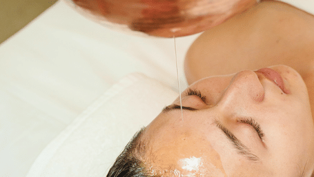 a person lying on bed to get spa massage