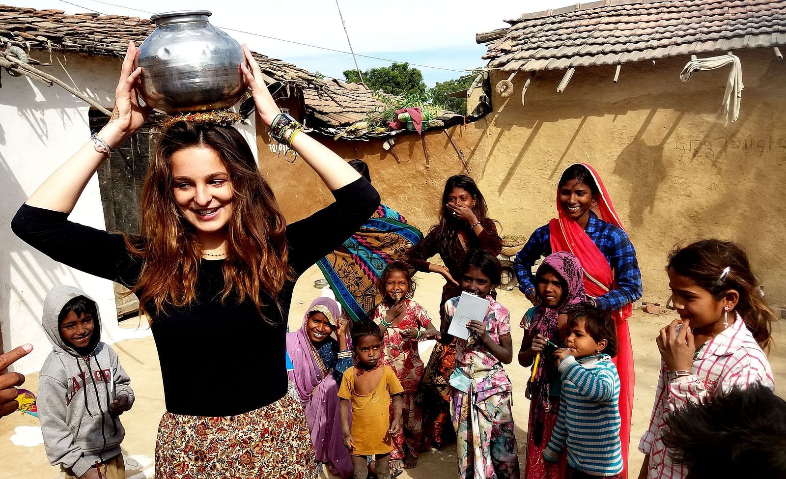 A group of people standing together one with a pot in her head- Shahpura Bagh.