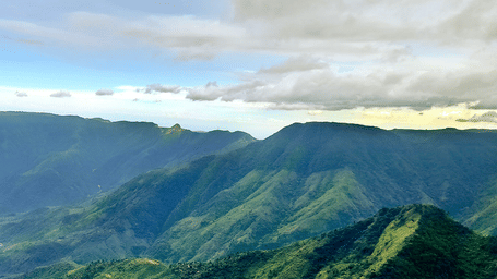 An aerial view of the rolling hills in the Northeast with a group of tourists overlooking them from a view point.