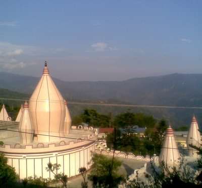 Aerial view of a temple with mountains in the backdrop