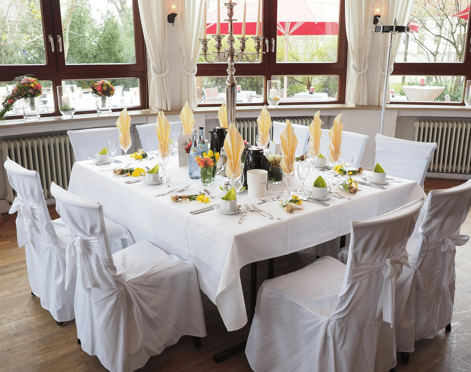 A table and chairs, elegantly decorated and arranged for an event.
