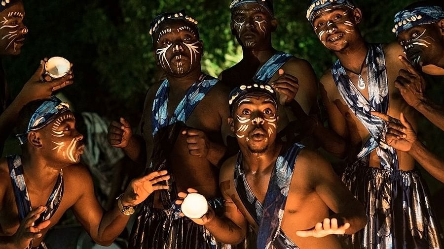 A group of tribal people in their traditional clothes with painted faces.