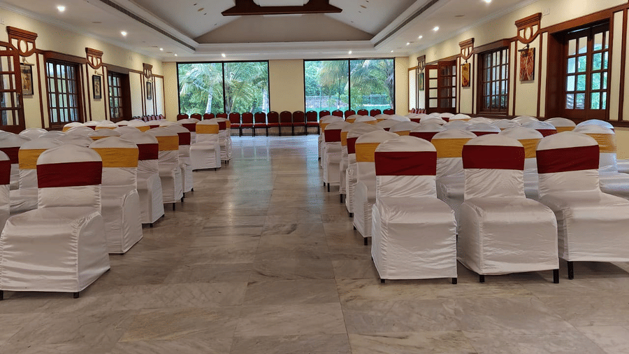 An event space at Avana Resorts, featuring decorated chairs and tables set for an event.