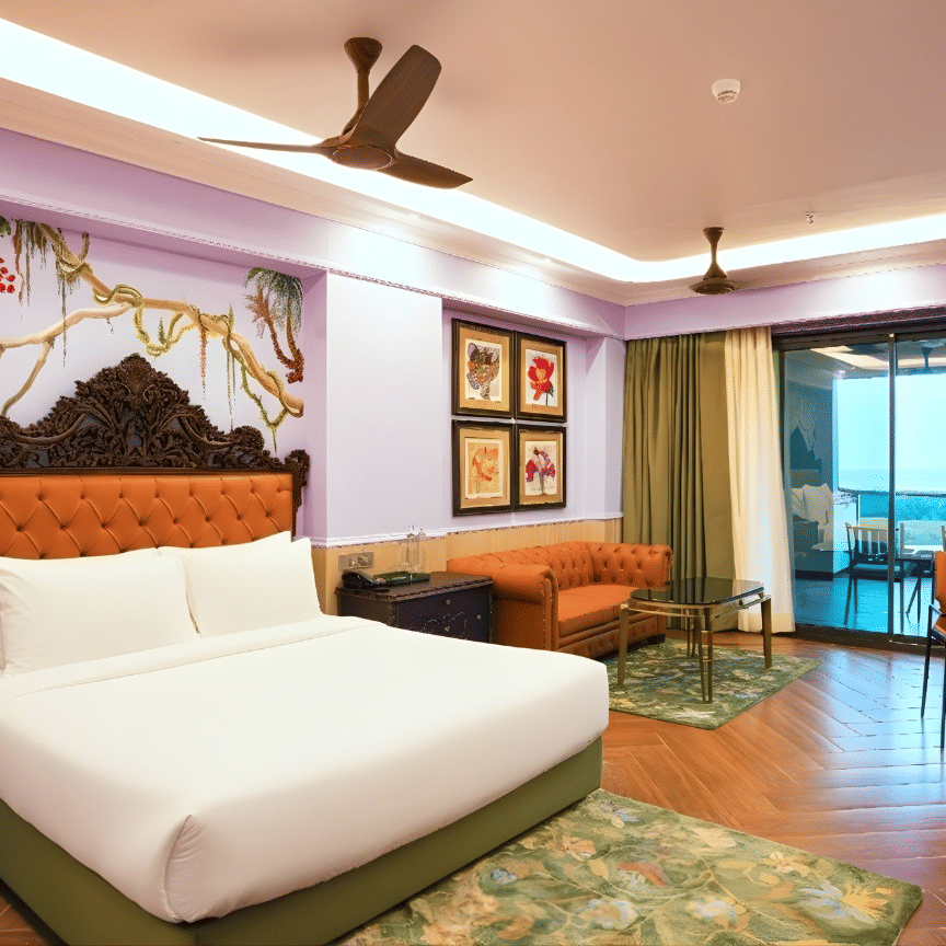 A brightly designed room featuring a double bed with upholstered headboard, floral mural, lounge chairs, balcony access and wooden flooring at MAYFAIR Bay Resort, Paradeep.